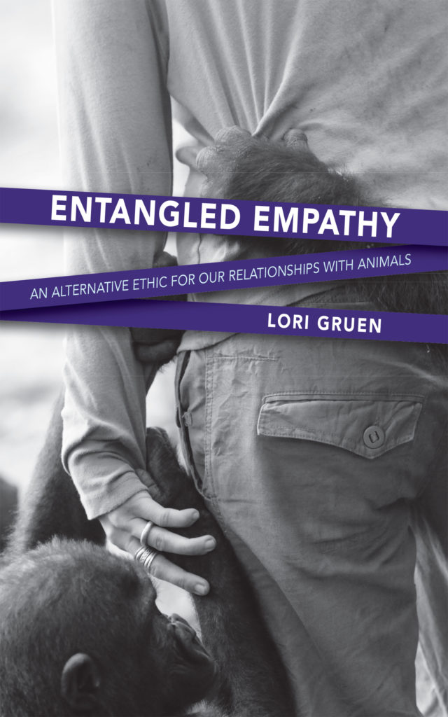 Entangled Empathy book cover shows the back of a woman holding hands with a baby chimpanzee